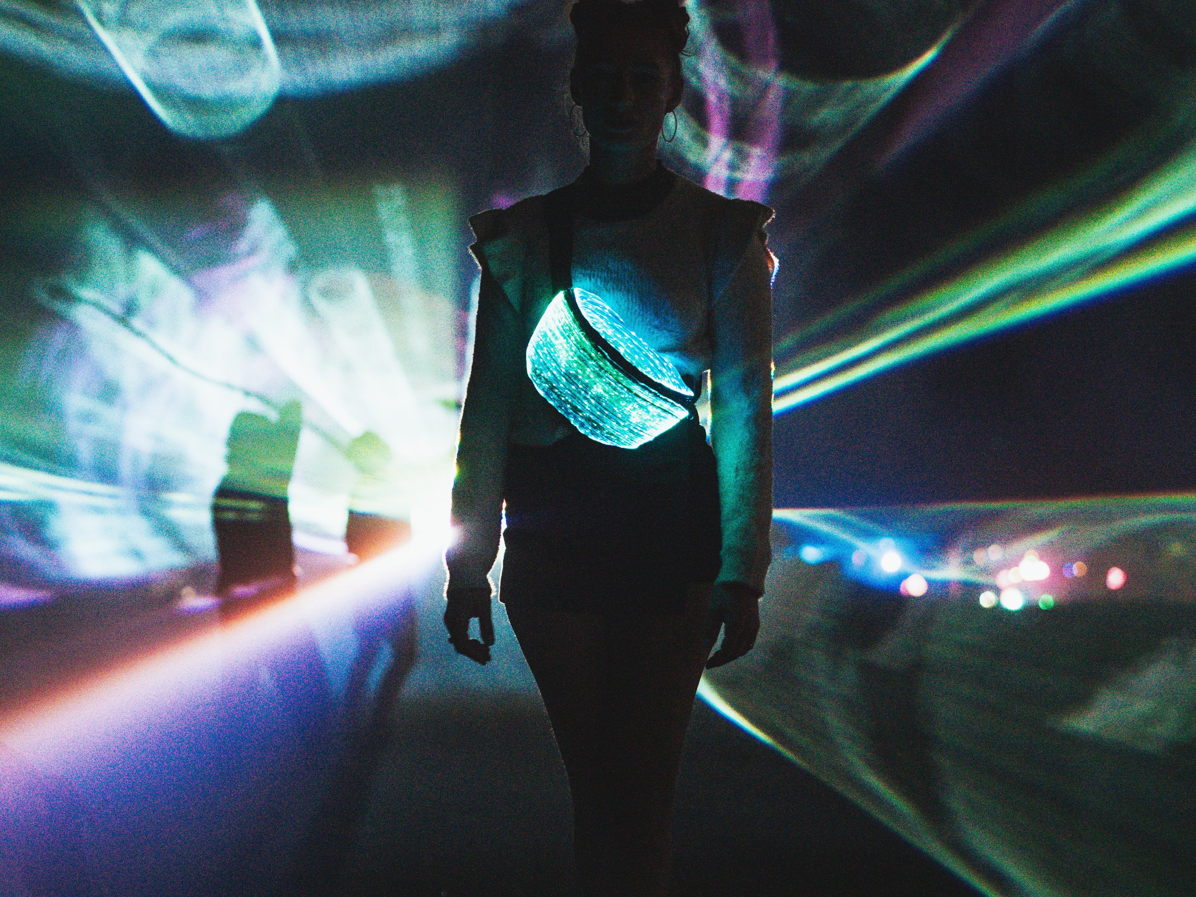 animated woman wearing the fanny pack on a festival, with lasers in the background