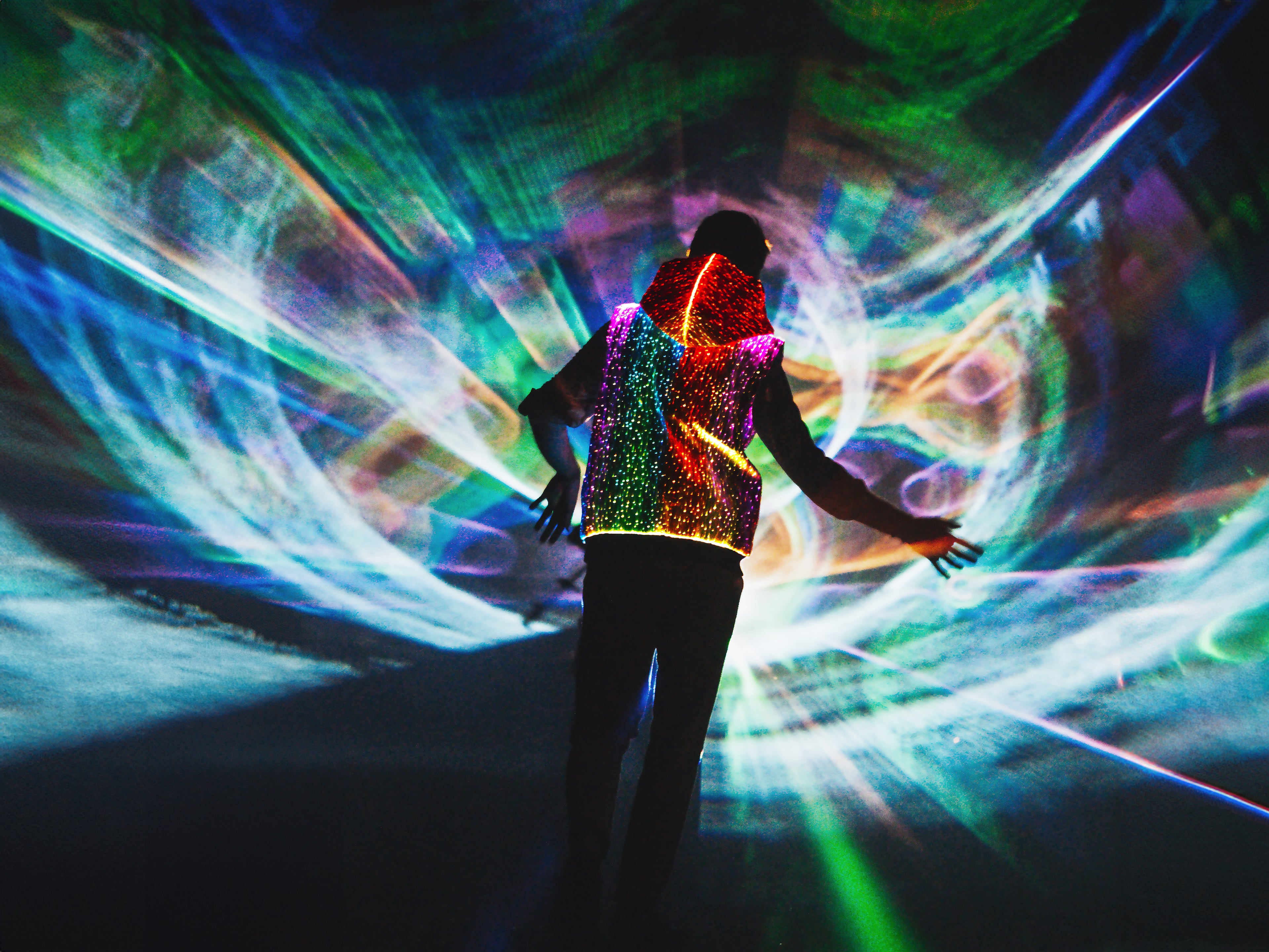 animated man in vest dancing in front of lasers